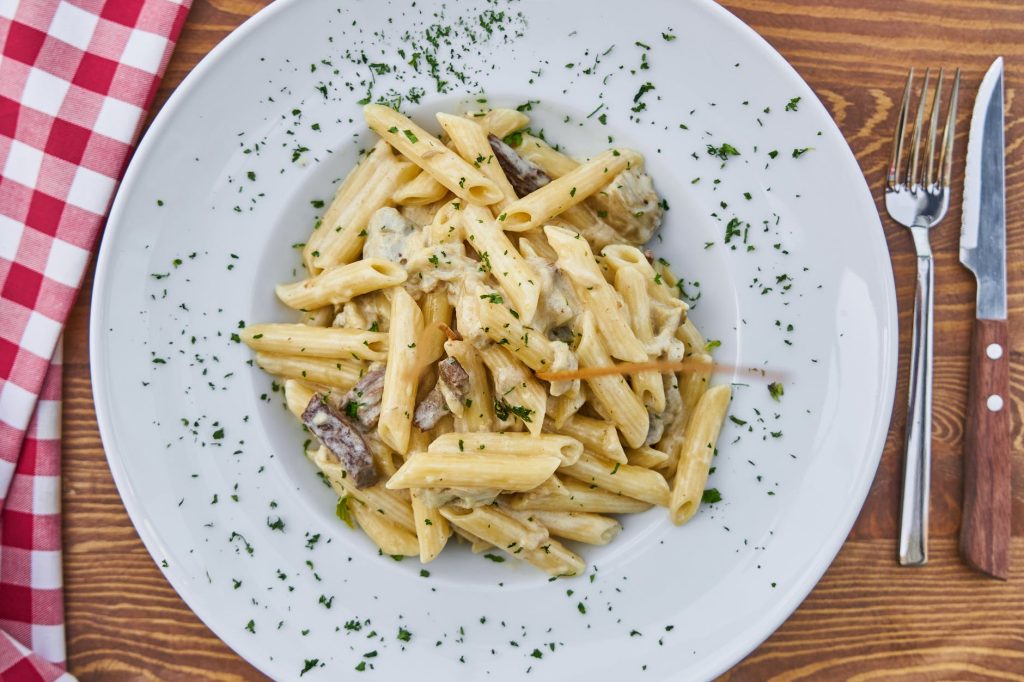 flat lay photography of pasta served in white plate